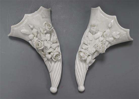 A pair of Victorian white glazed porcelain floral encrusted cornucopia wall pockets